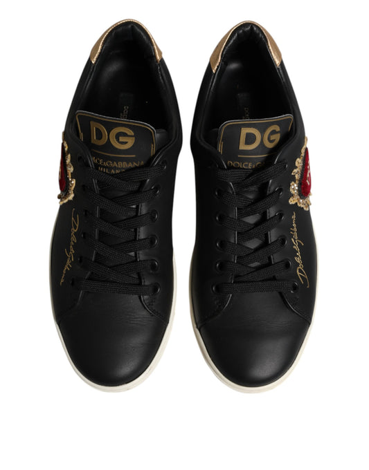 Pair of black leather sneakers with gold accents and a red heart logo on the side