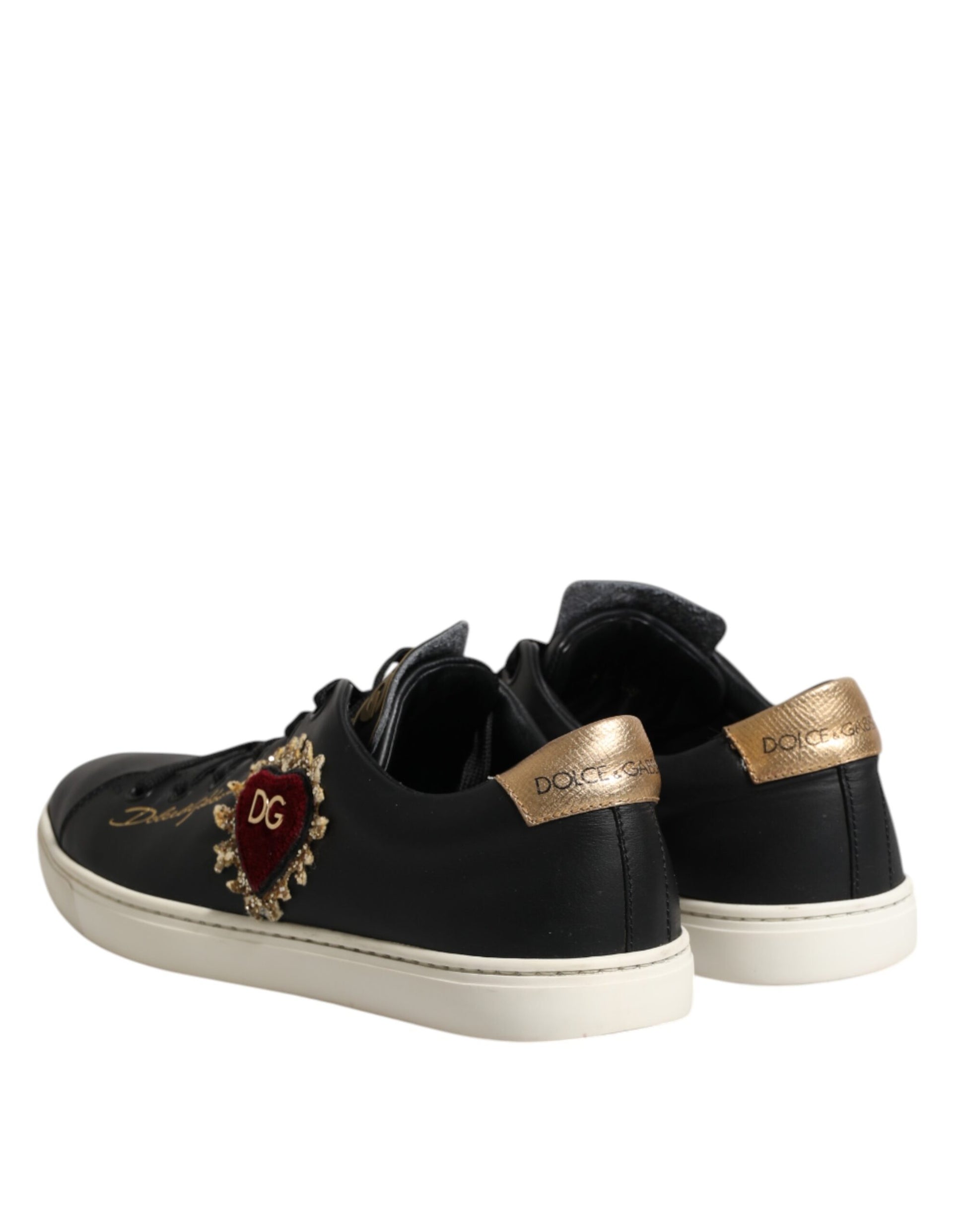 Pair of black leather sneakers with gold accents and a heart design on the side