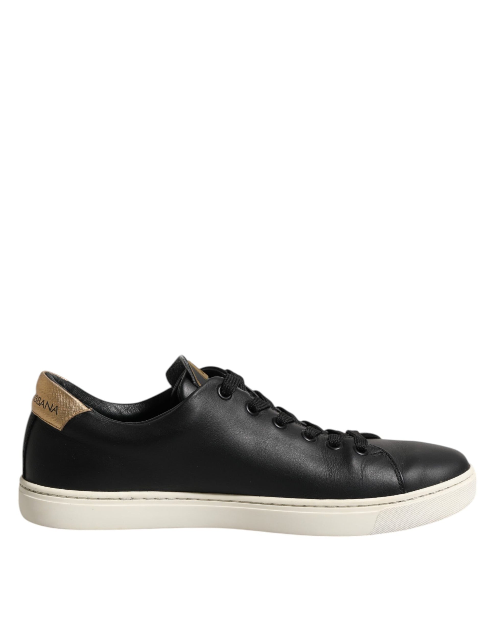 Black leather sneakers with gold accents, featuring a sacred heart design on the side
