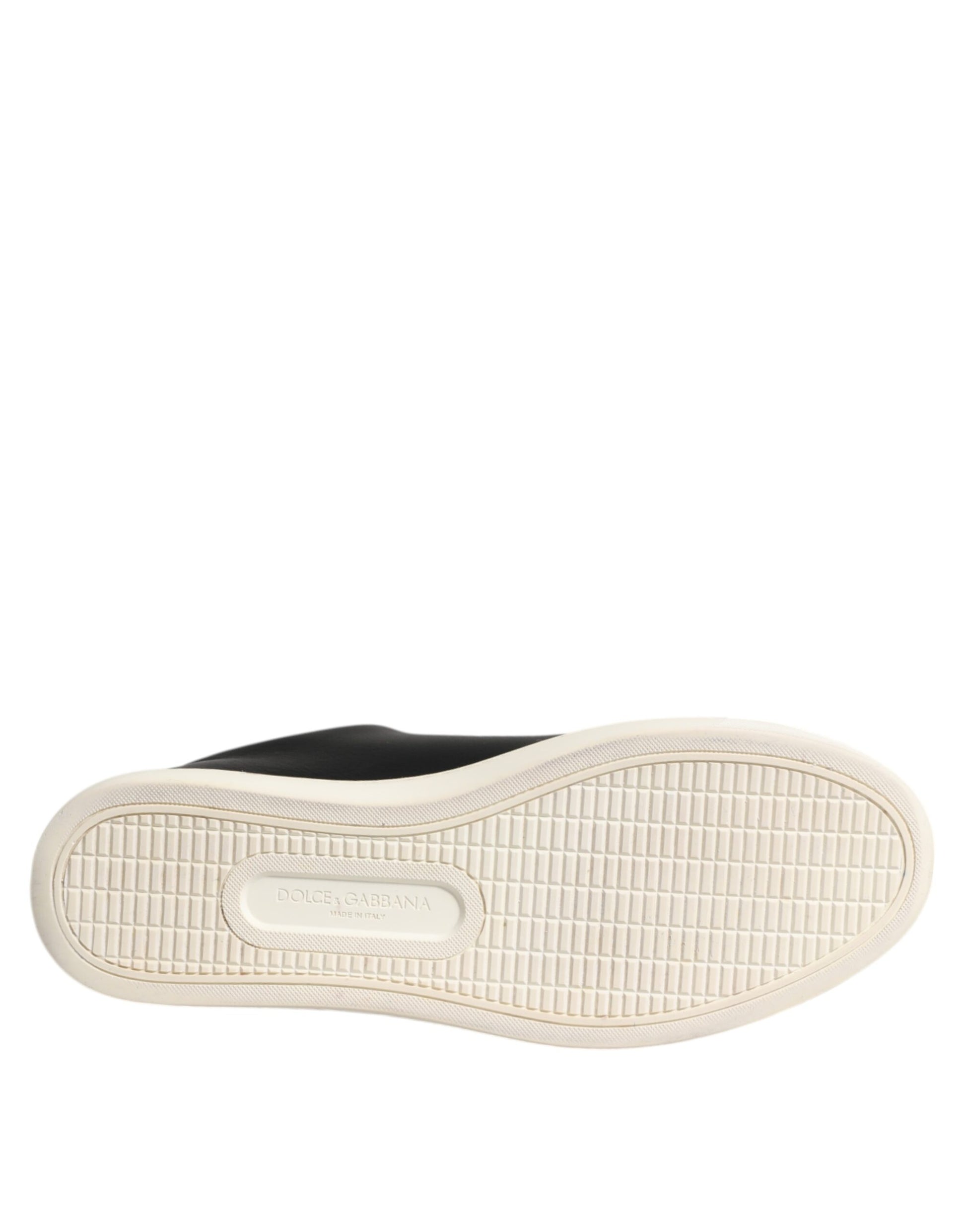 A single black leather sneaker with a white rubber sole and a gold-colored heart embossed on the side