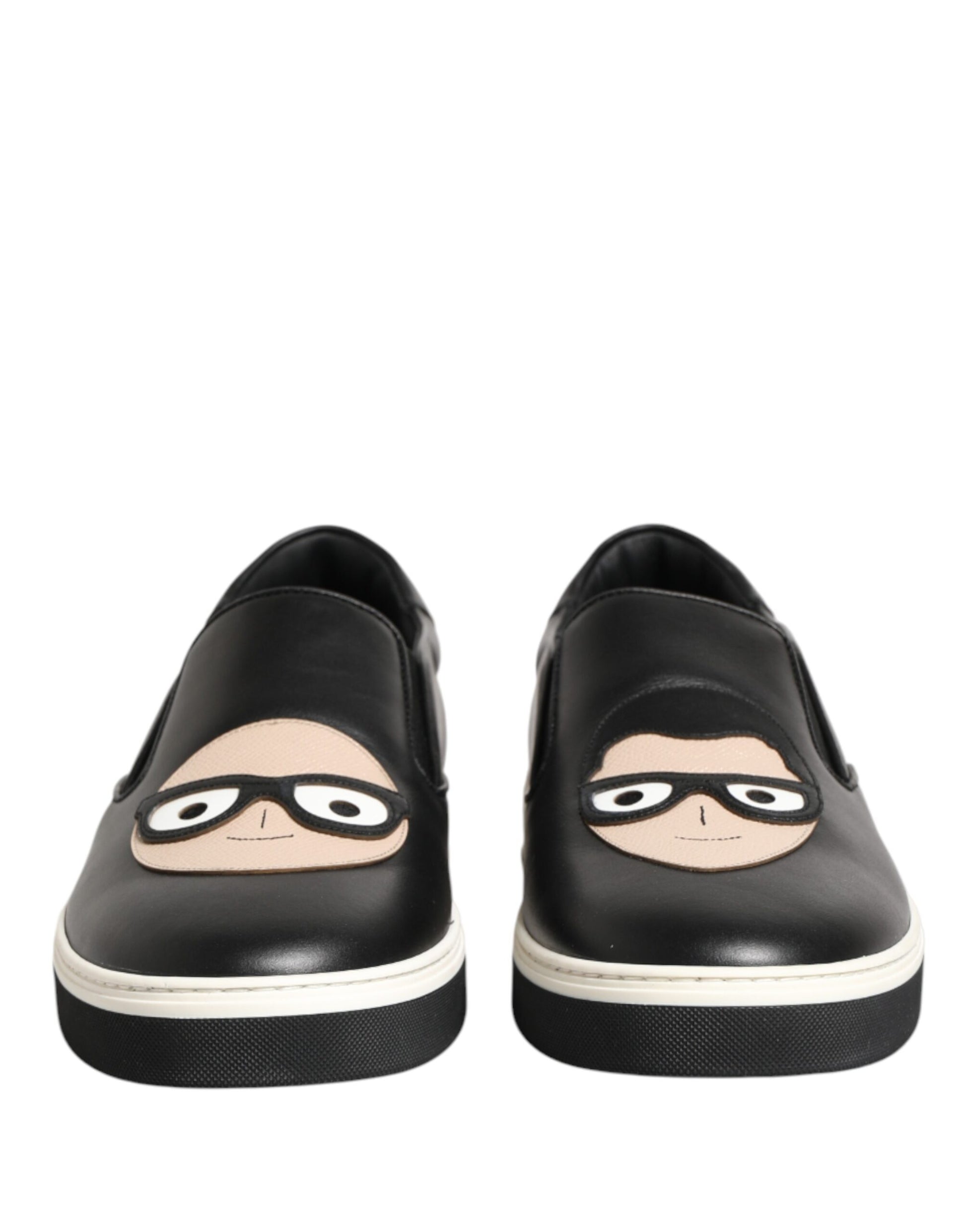 Pair of black shoes with cartoon faces on them
