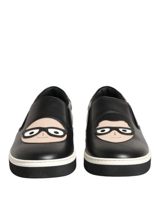 Pair of black shoes with cartoon faces on them
