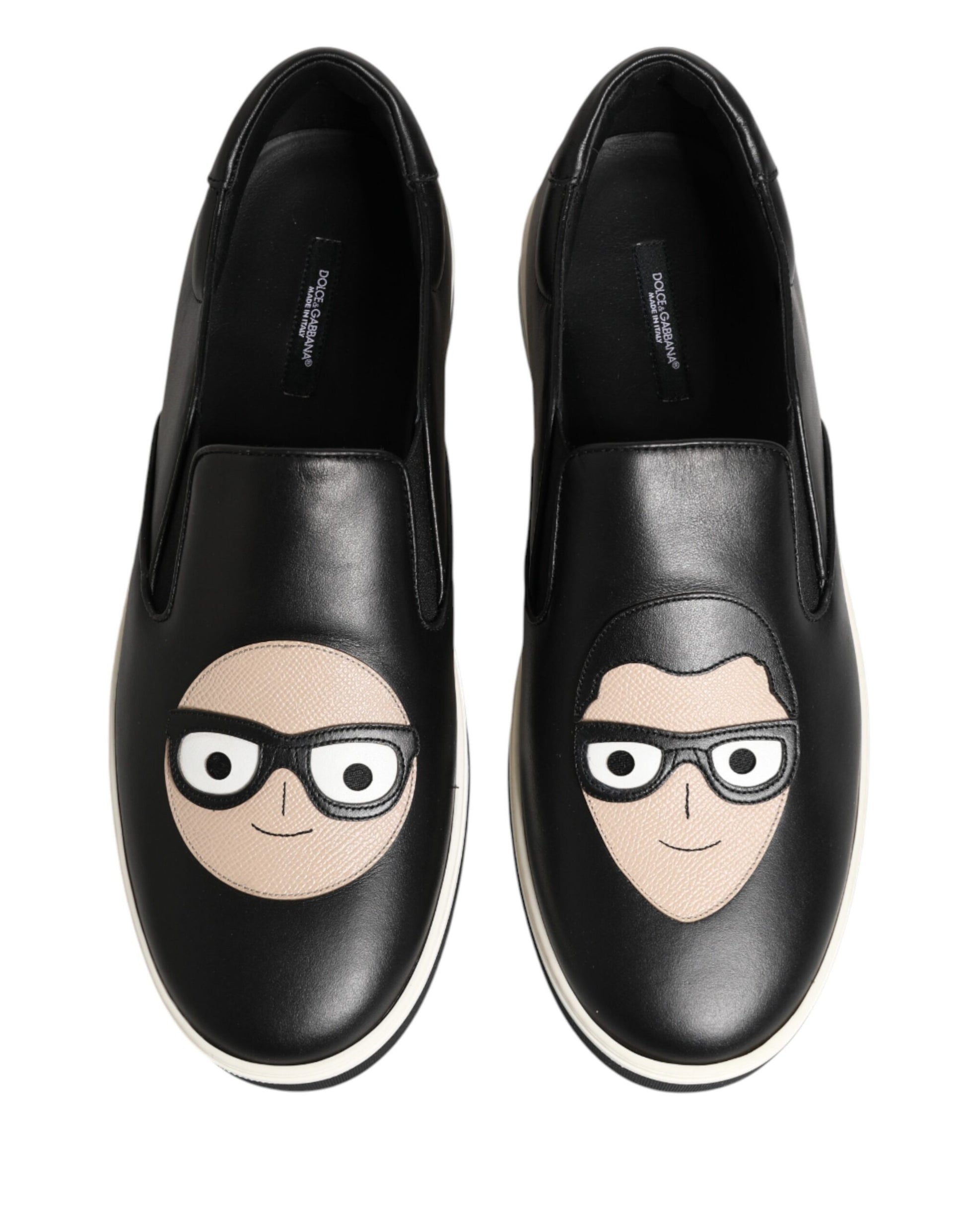 Pair of black shoes with cartoon faces on them