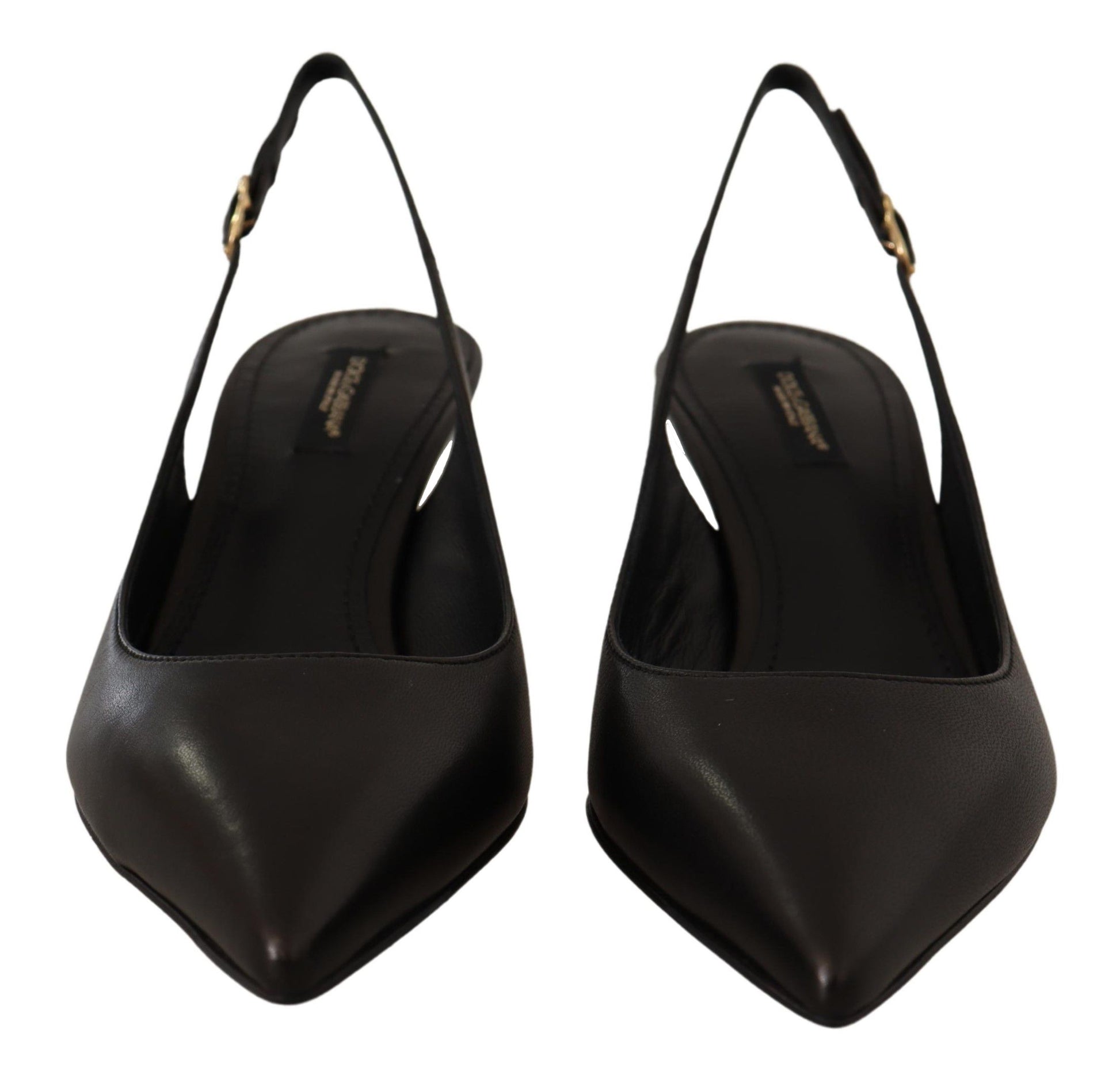 Pair of black high heel shoes with pointed toe and strap detailing