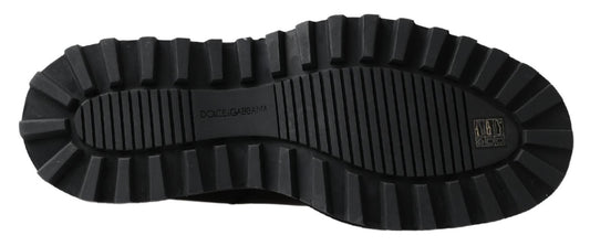 Black rubber boot with deep treads and a pull tab on the back