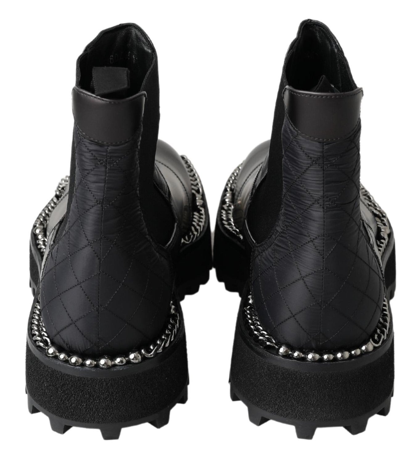 Pair of black leather boots with silver studs and a fur lining