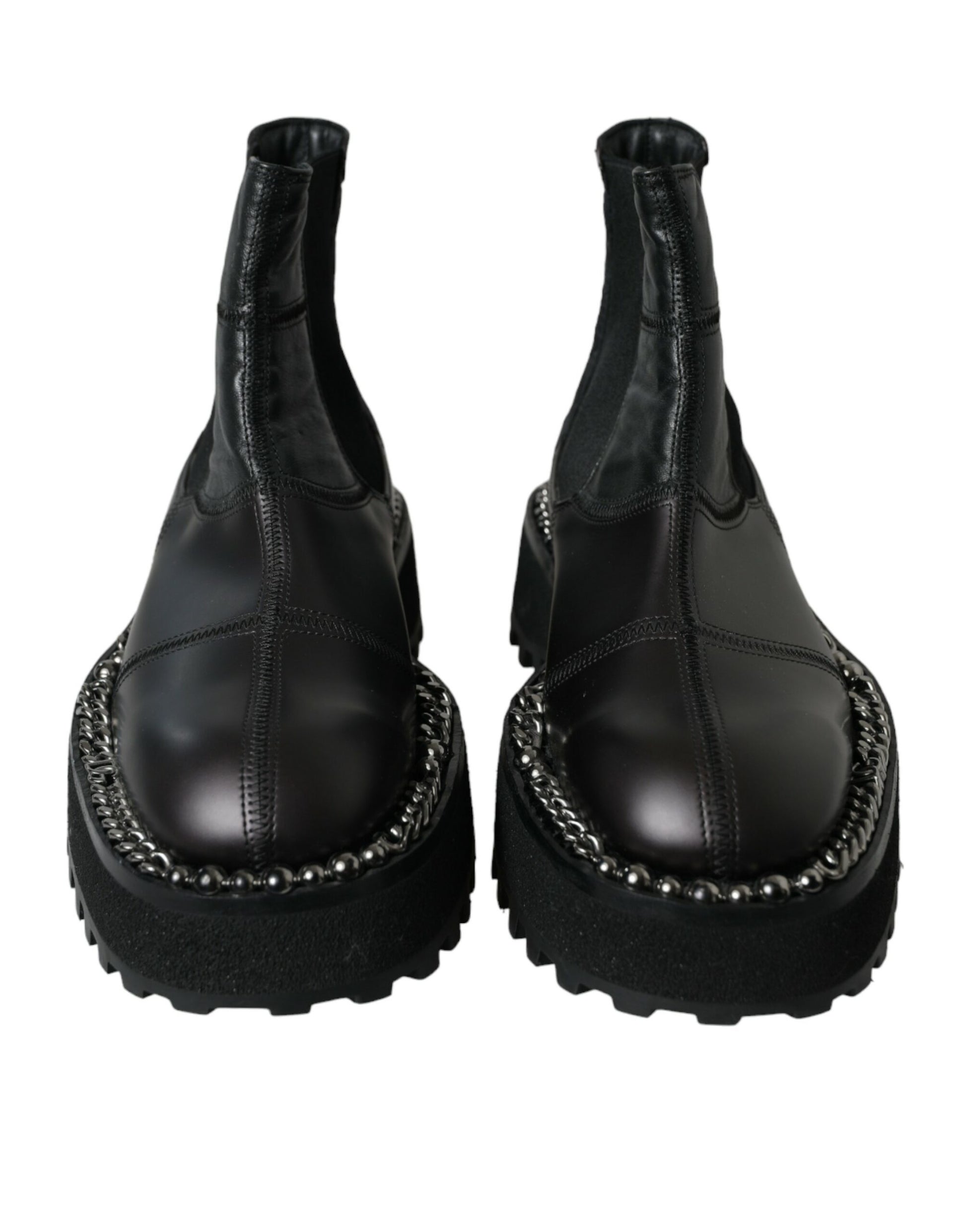 Pair of black leather boots with silver studs and a thick sole