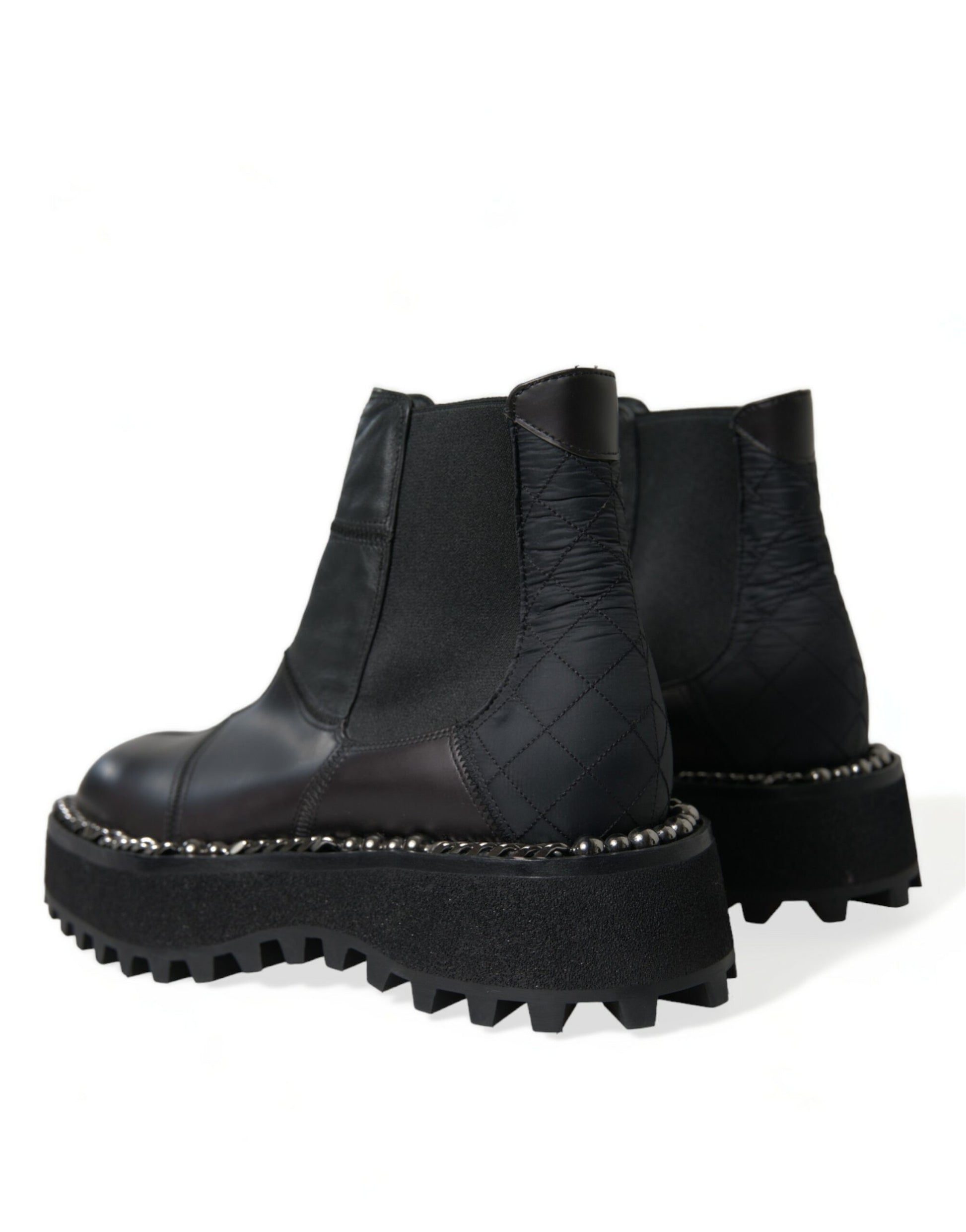 Pair of black ankle boots with chunky heels and silver studs on soles