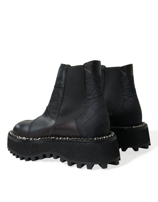 Pair of black ankle boots with chunky heels and silver studs on soles