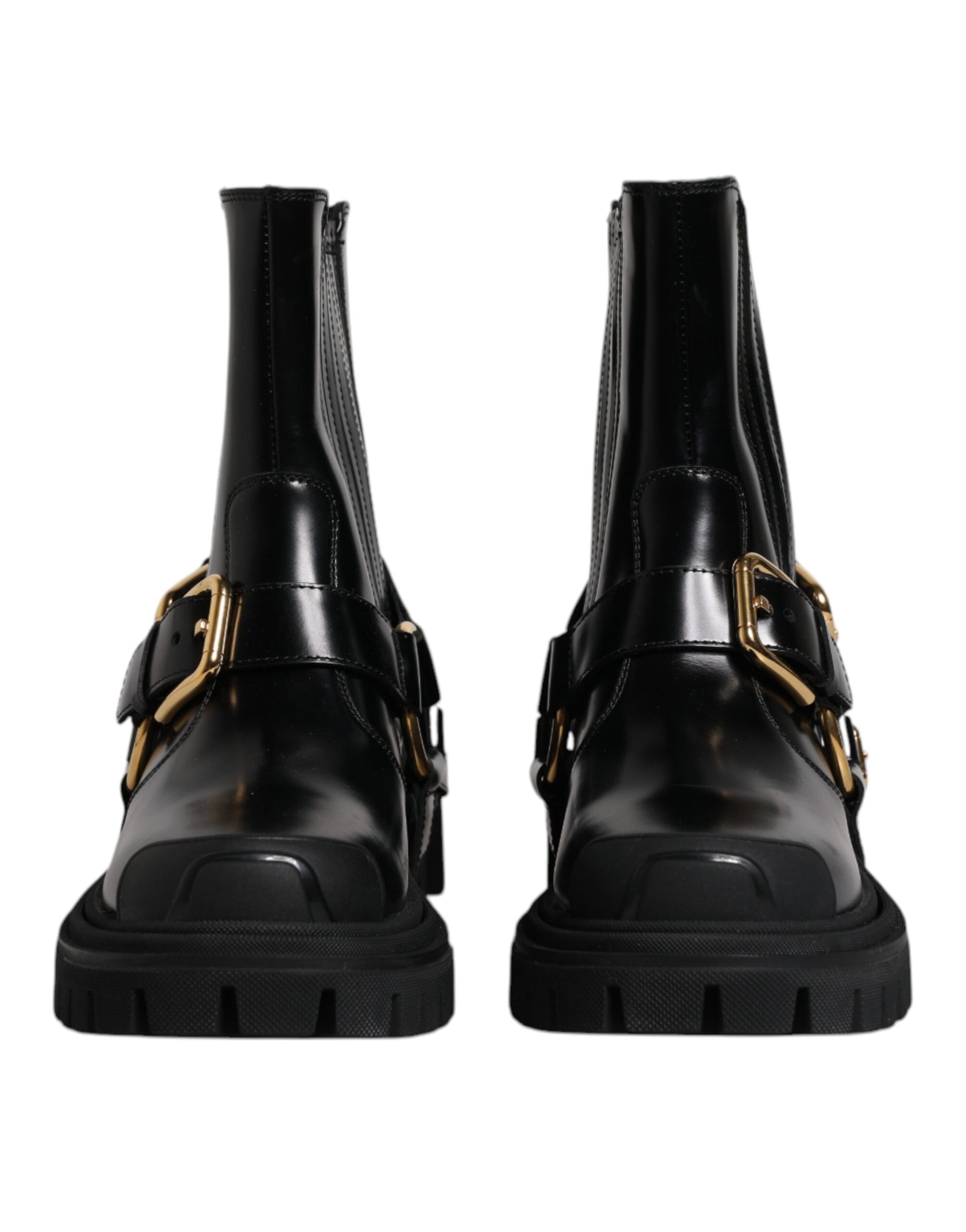 Pair of black leather boots with gold buckles