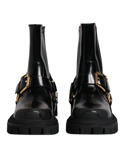 Pair of black leather boots with gold buckles