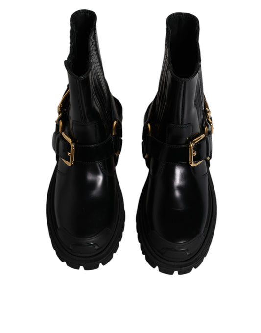 Pair of black leather boots with gold buckles