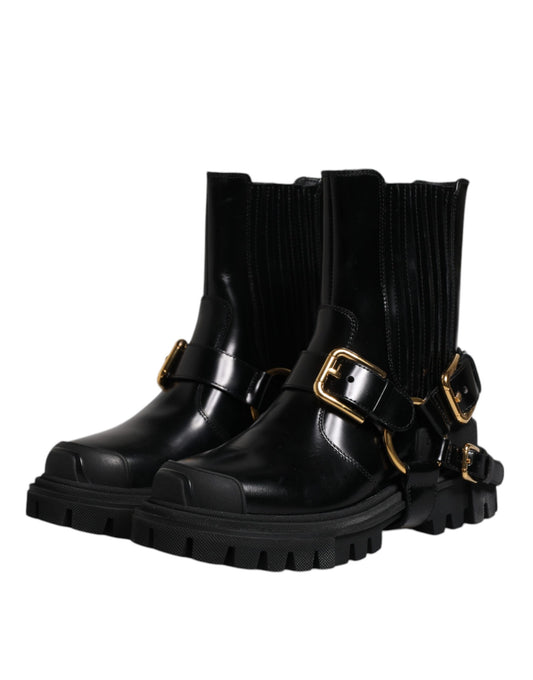 Black leather ankle boots with gold buckles