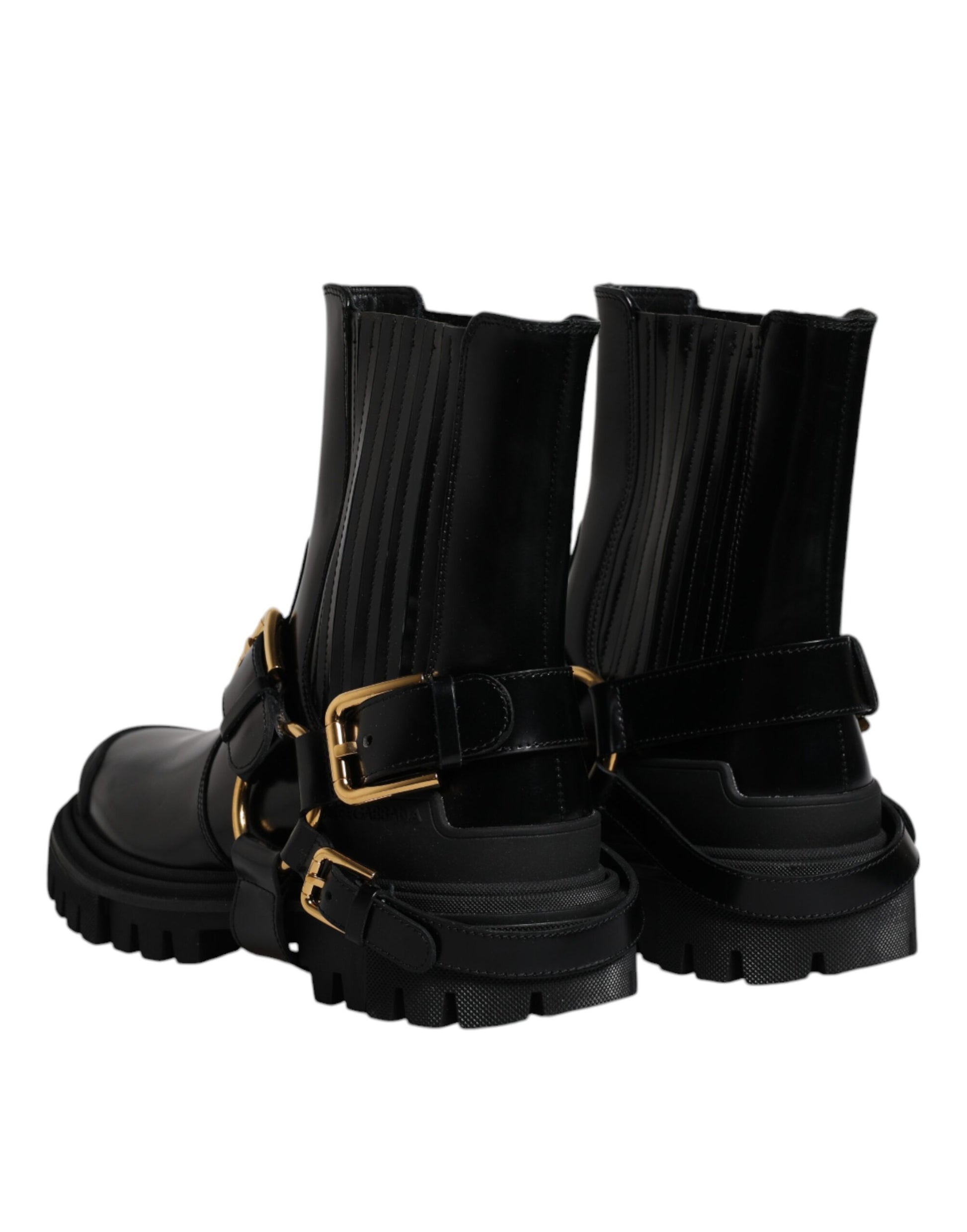 Pair of black boots with gold buckles