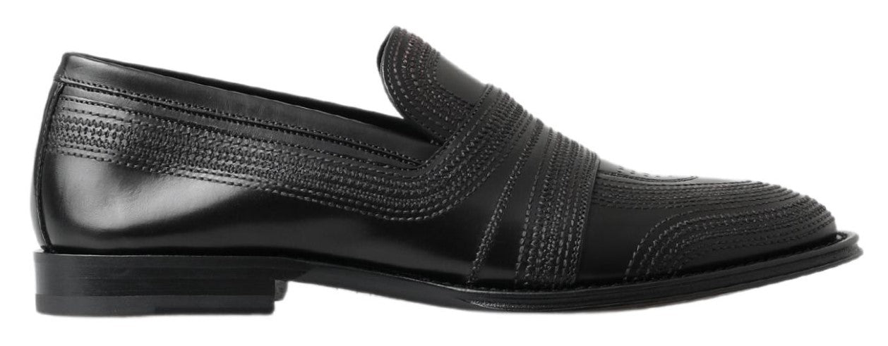 Black leather loafer shoes with embossed design and strap detailing