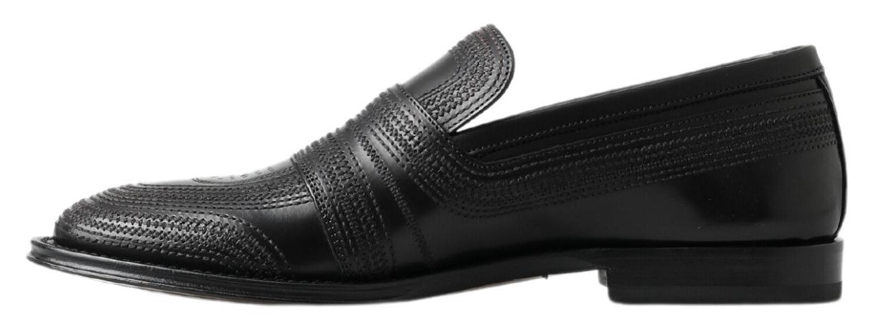 Pair of black dress shoes with a patterned design on the vamp and toe cap
