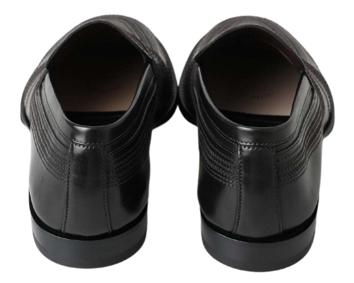 Pair of black dress shoes with laces and a small heel