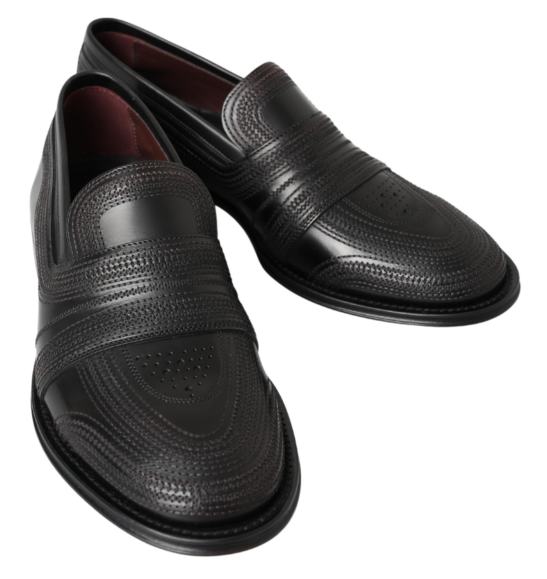 Pair of black dress shoes with a patterned design on the vamp and toe cap