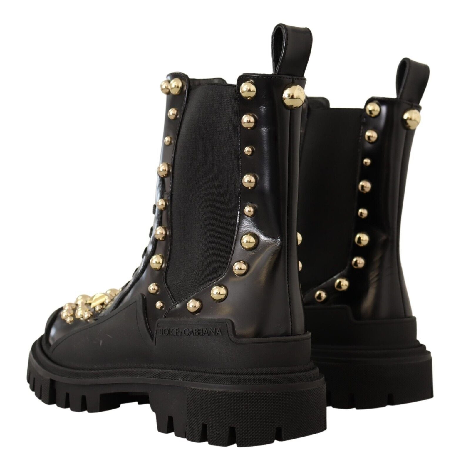 Pair of black boots with gold studs and a chunky heel