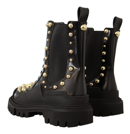 Pair of black boots with gold studs and a chunky heel