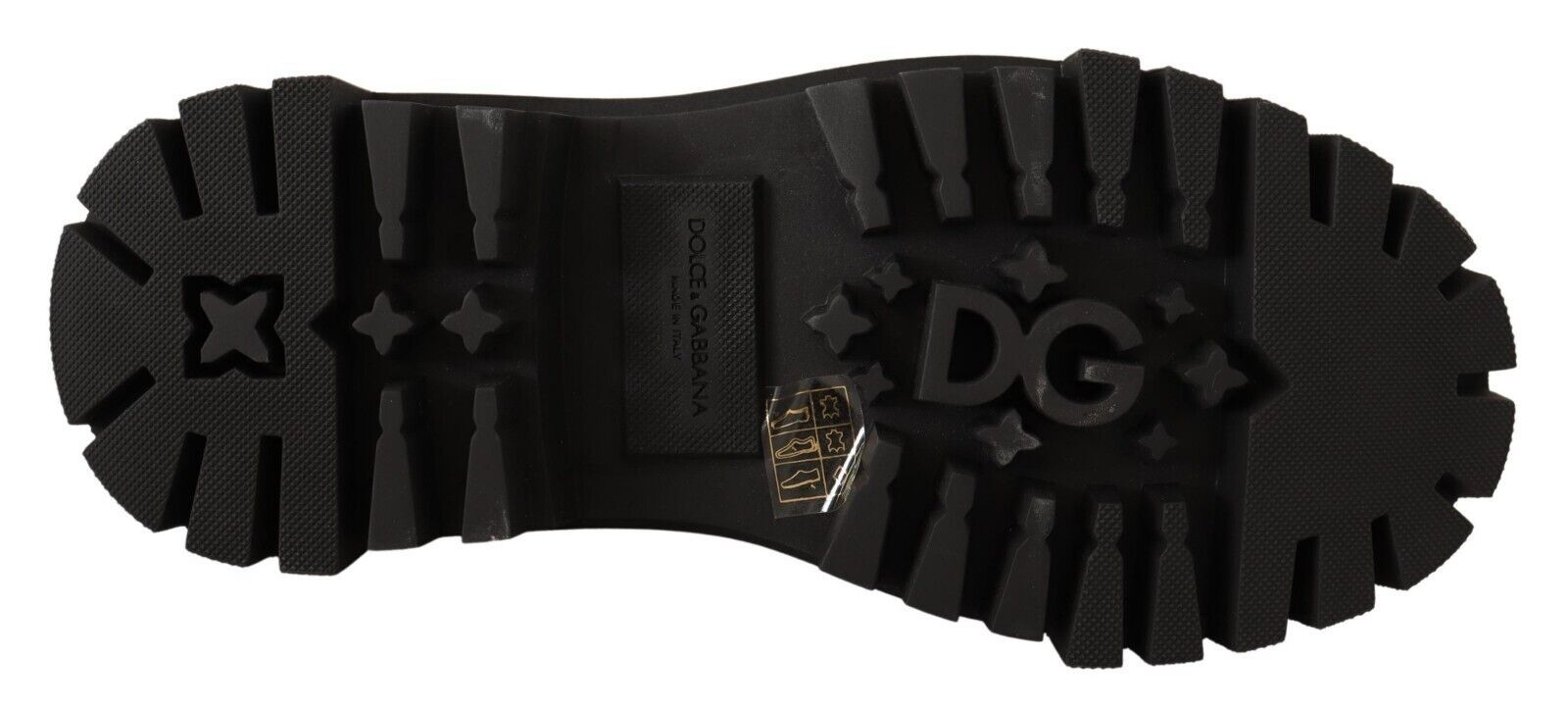 Pair of black boots with white stars and lettering on soles