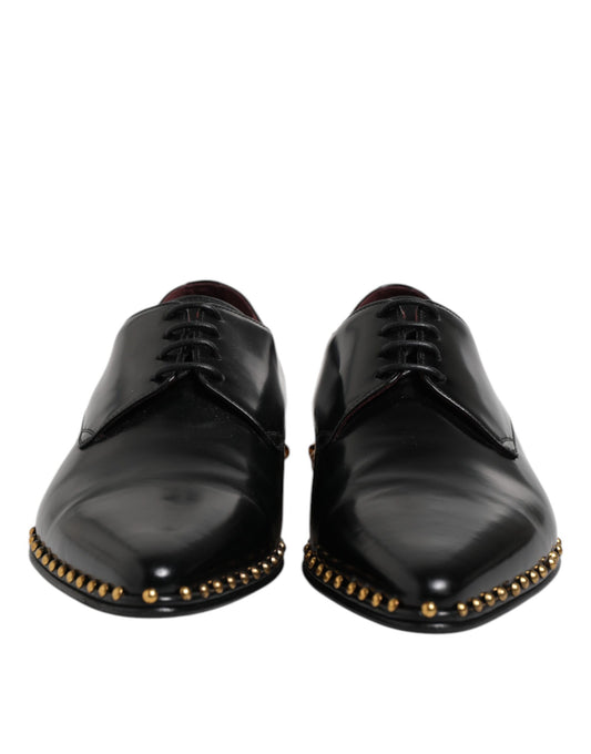 Pair of black leather shoes with gold studs and laces, designed by Dolce & Gabbana