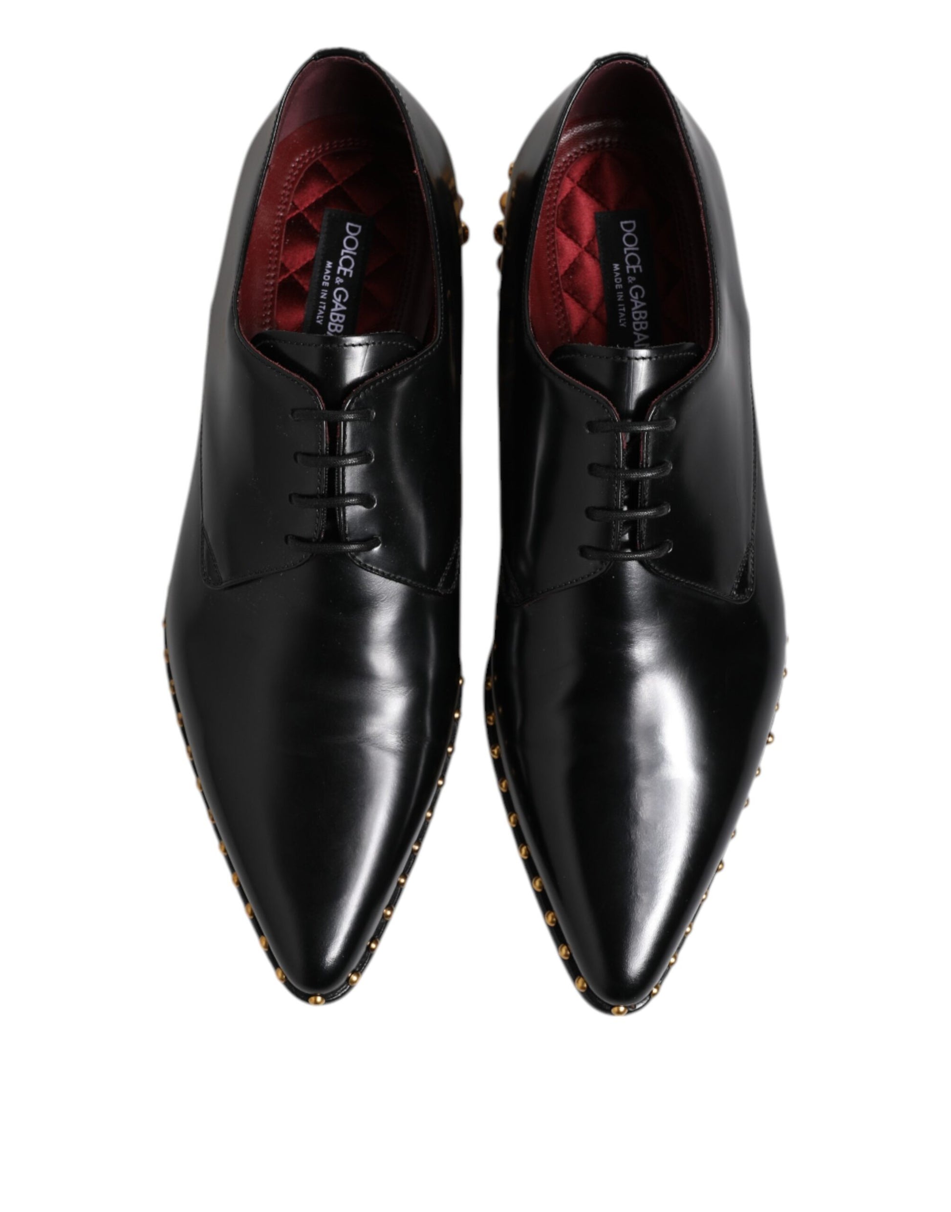 Pair of black leather dress shoes with red studs, laces and sole detailing