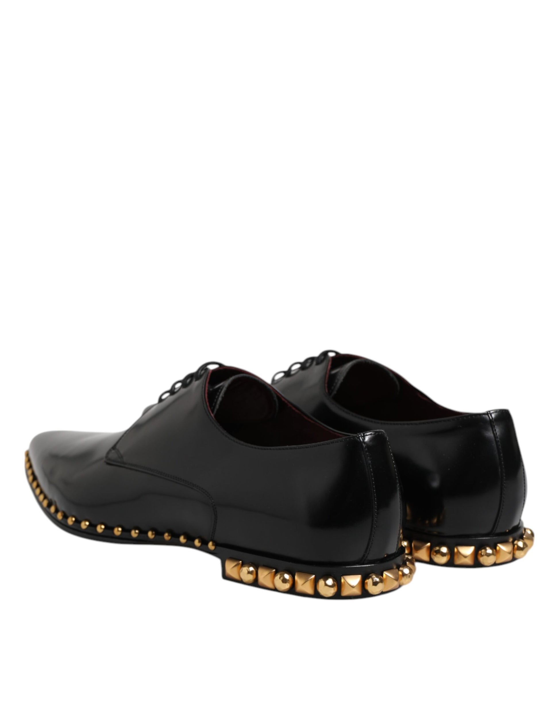 Pair of black leather shoes with gold studs, featuring a derby style and laces