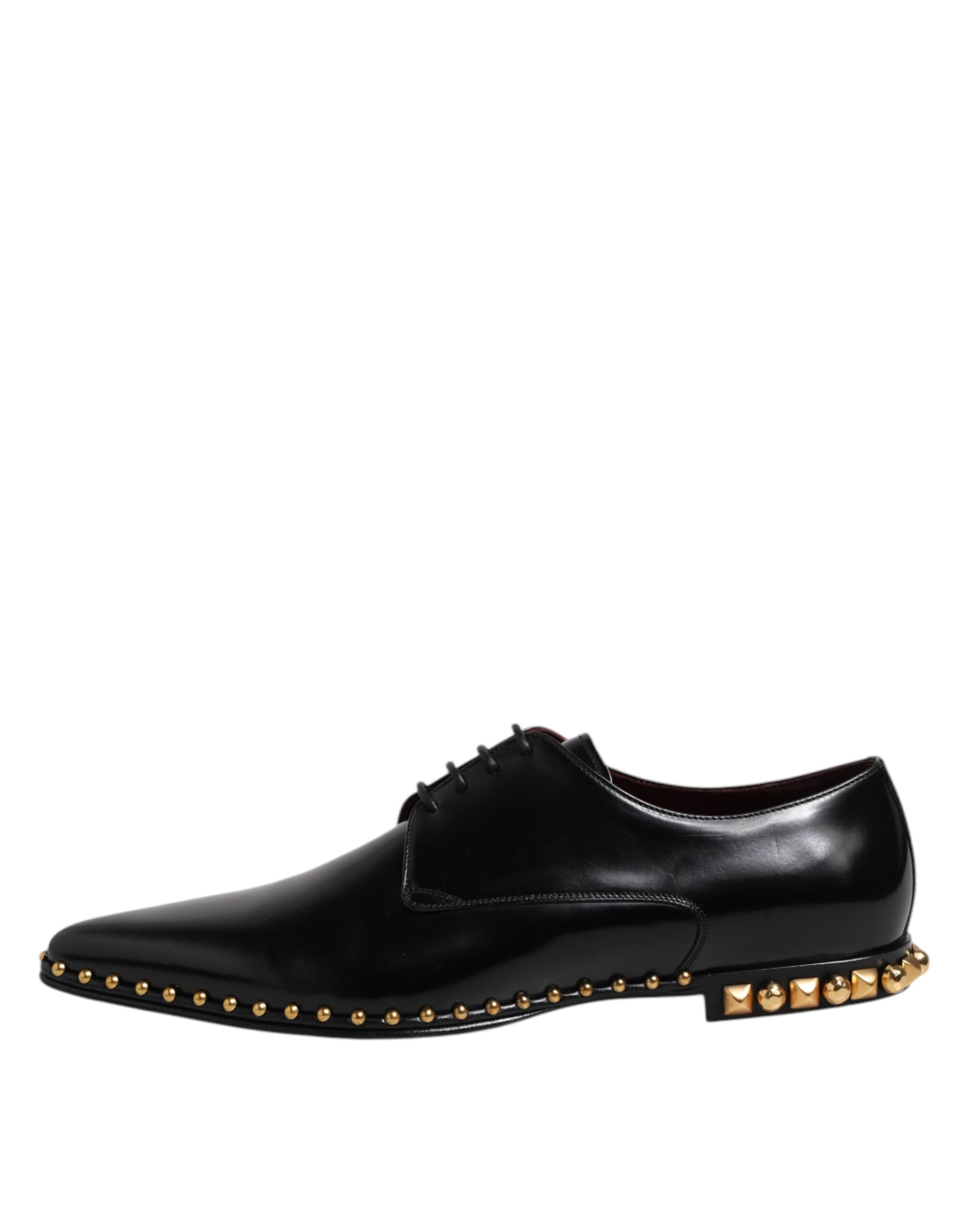 A pair of black leather shoes with gold studs and laces, designed by Dolce & Gabbana