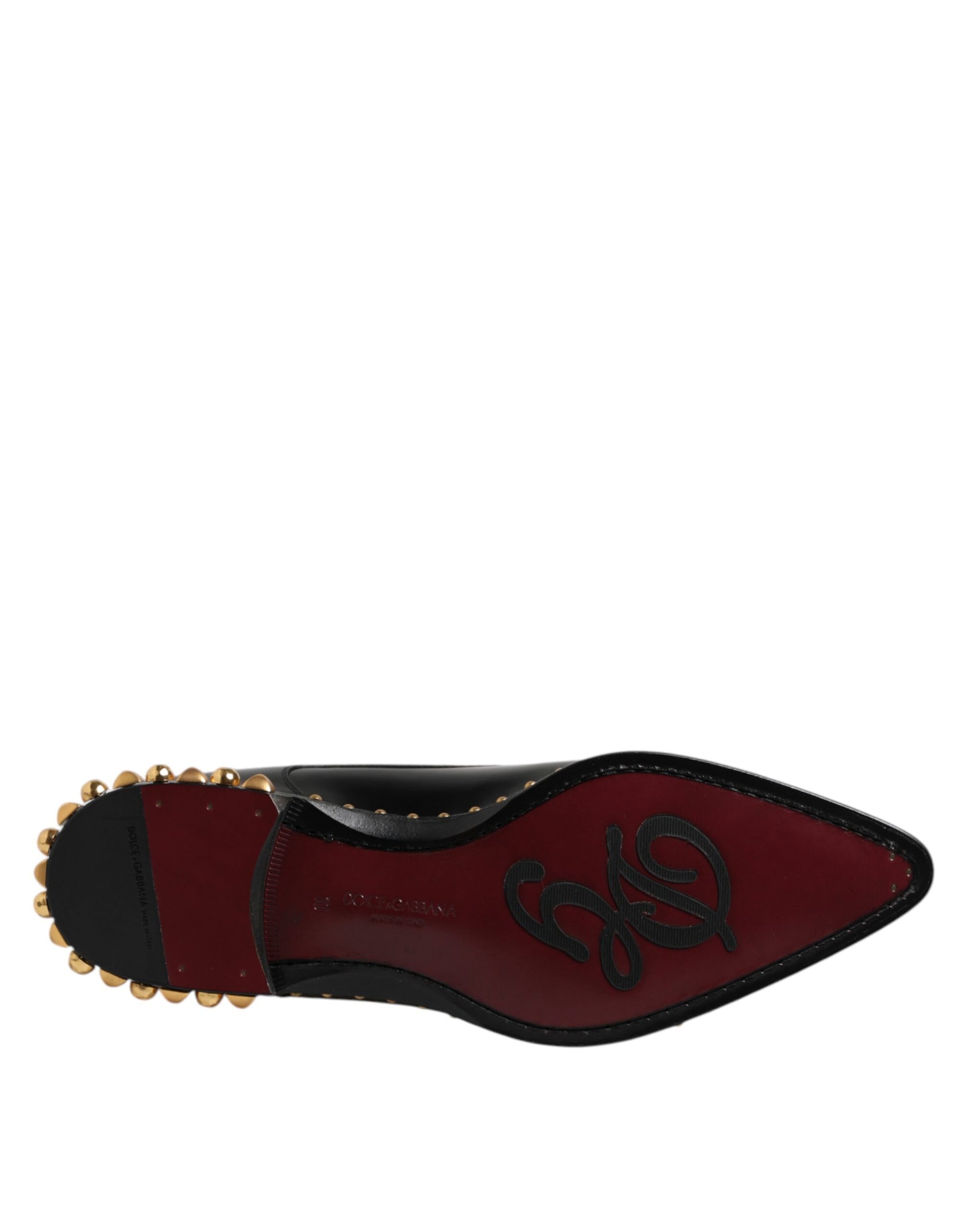 A pair of black leather studded derby shoes with gold accents, designed by Dolce & Gabbana