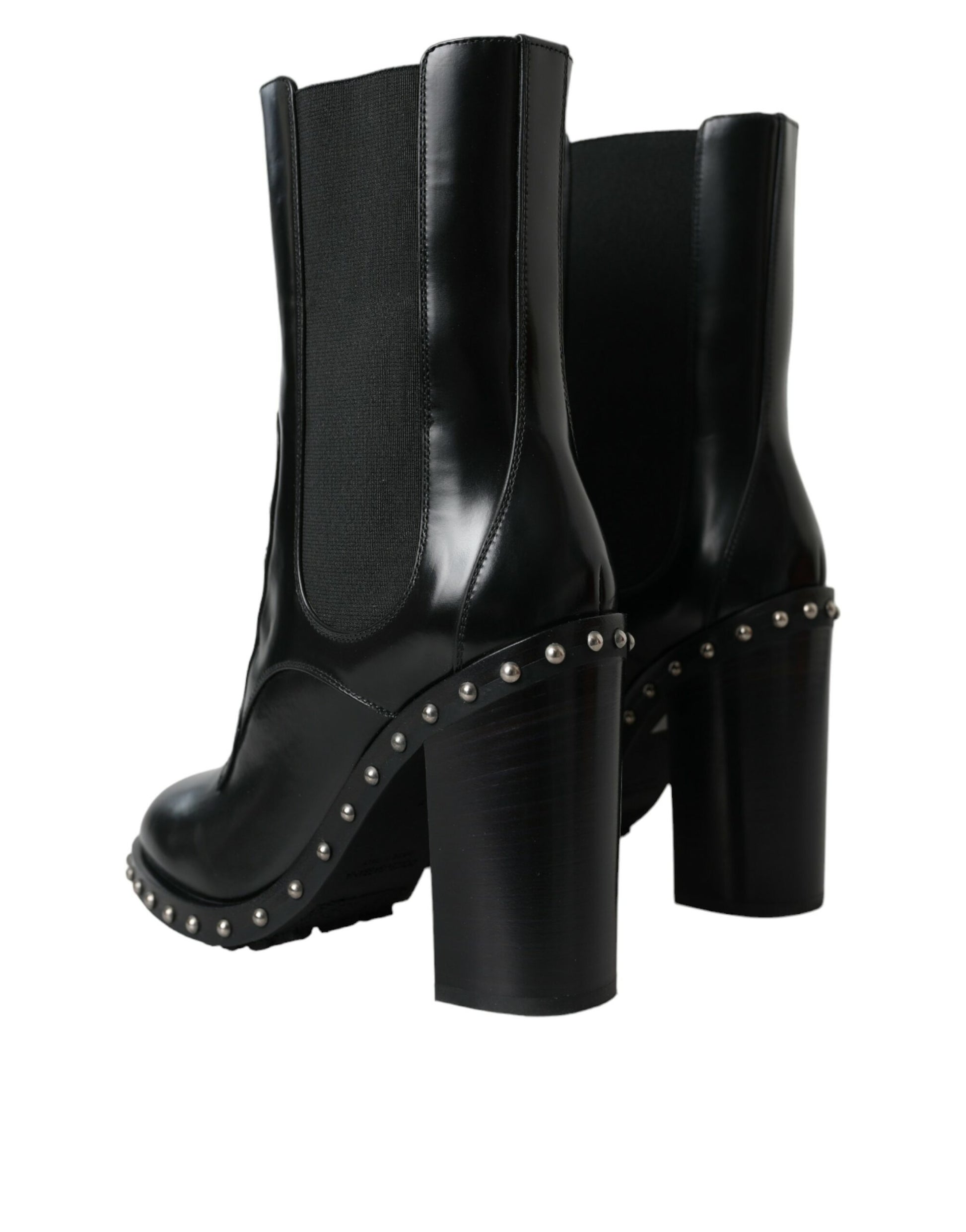 Pair of black knee high boots with studded details and a chunky heel