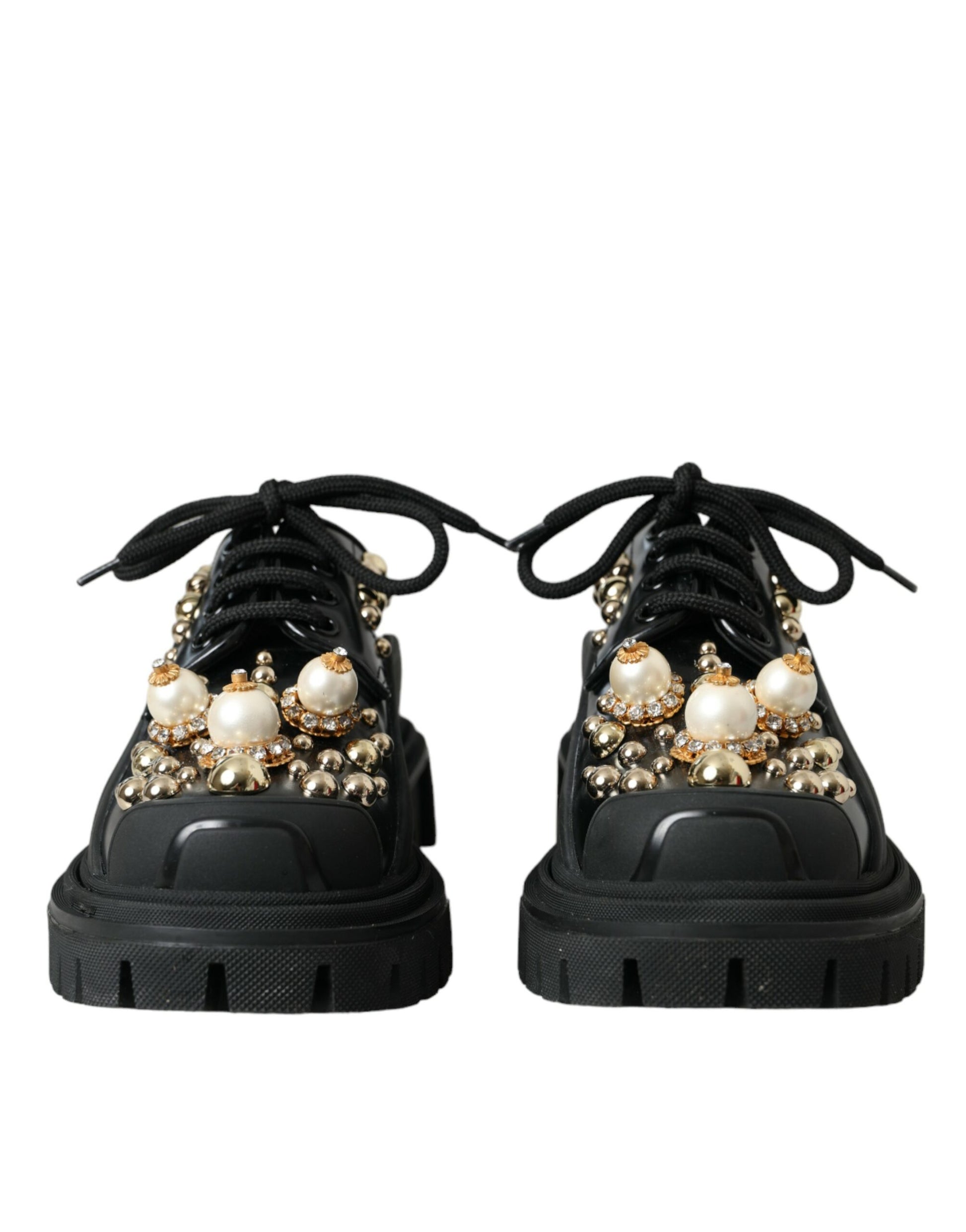 Pair of black sneakers with embellishments on top