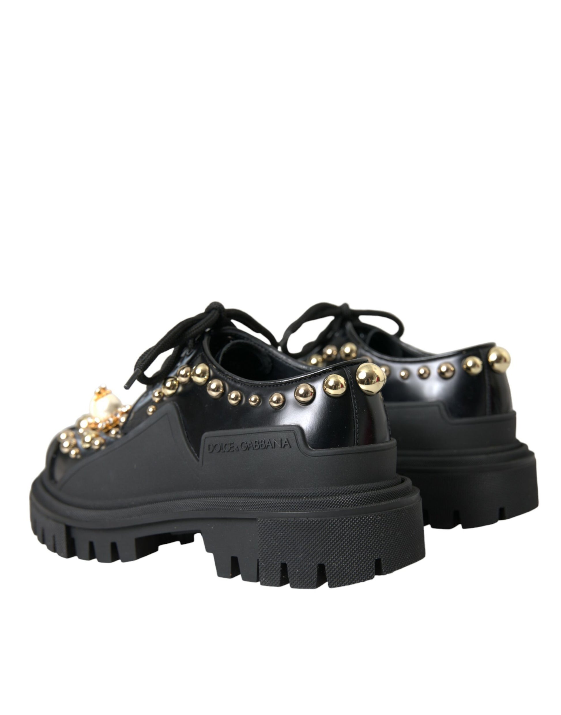 Pair of black boots with gold studs and a chunky sole