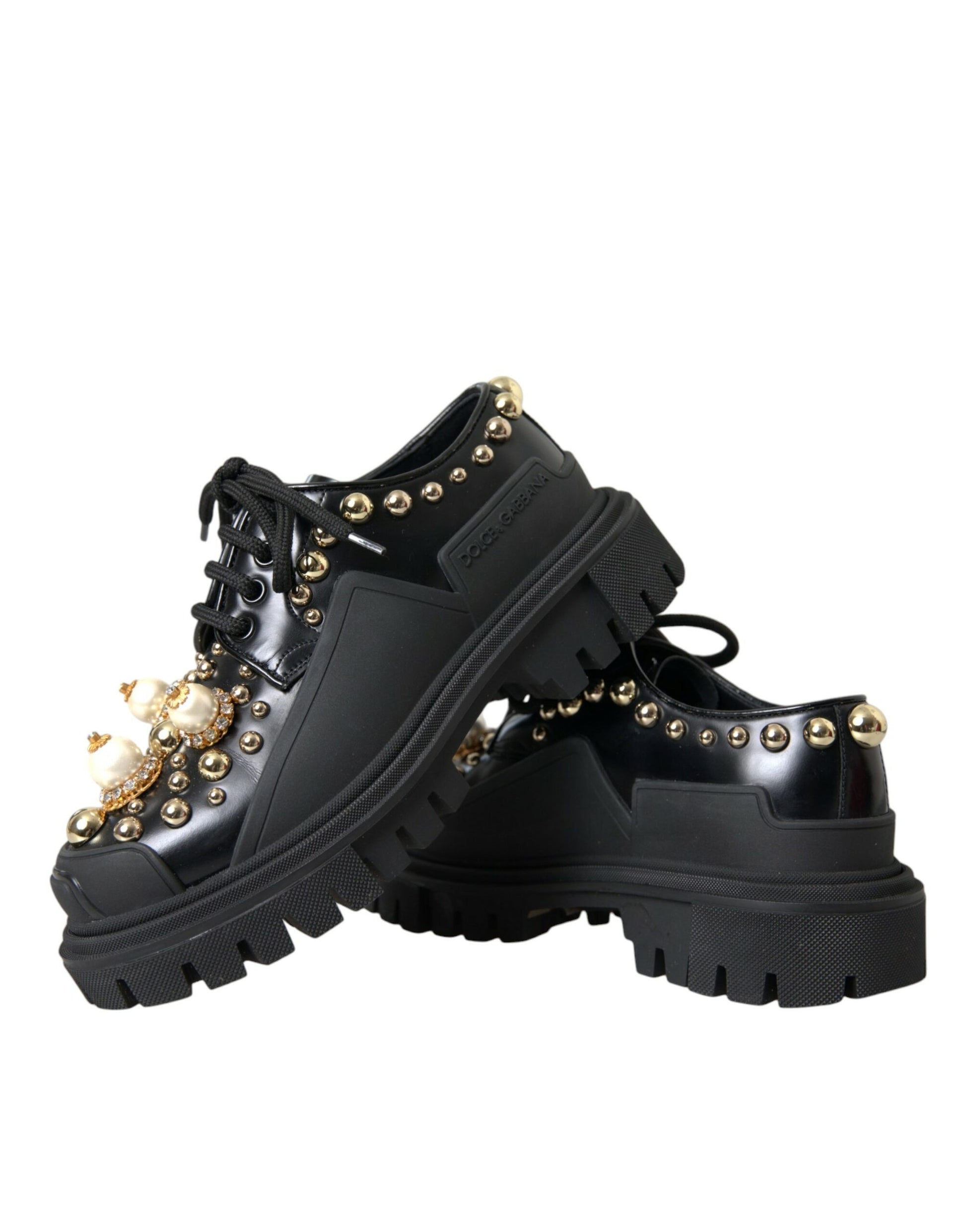 Pair of black boots with gold studs and buckles