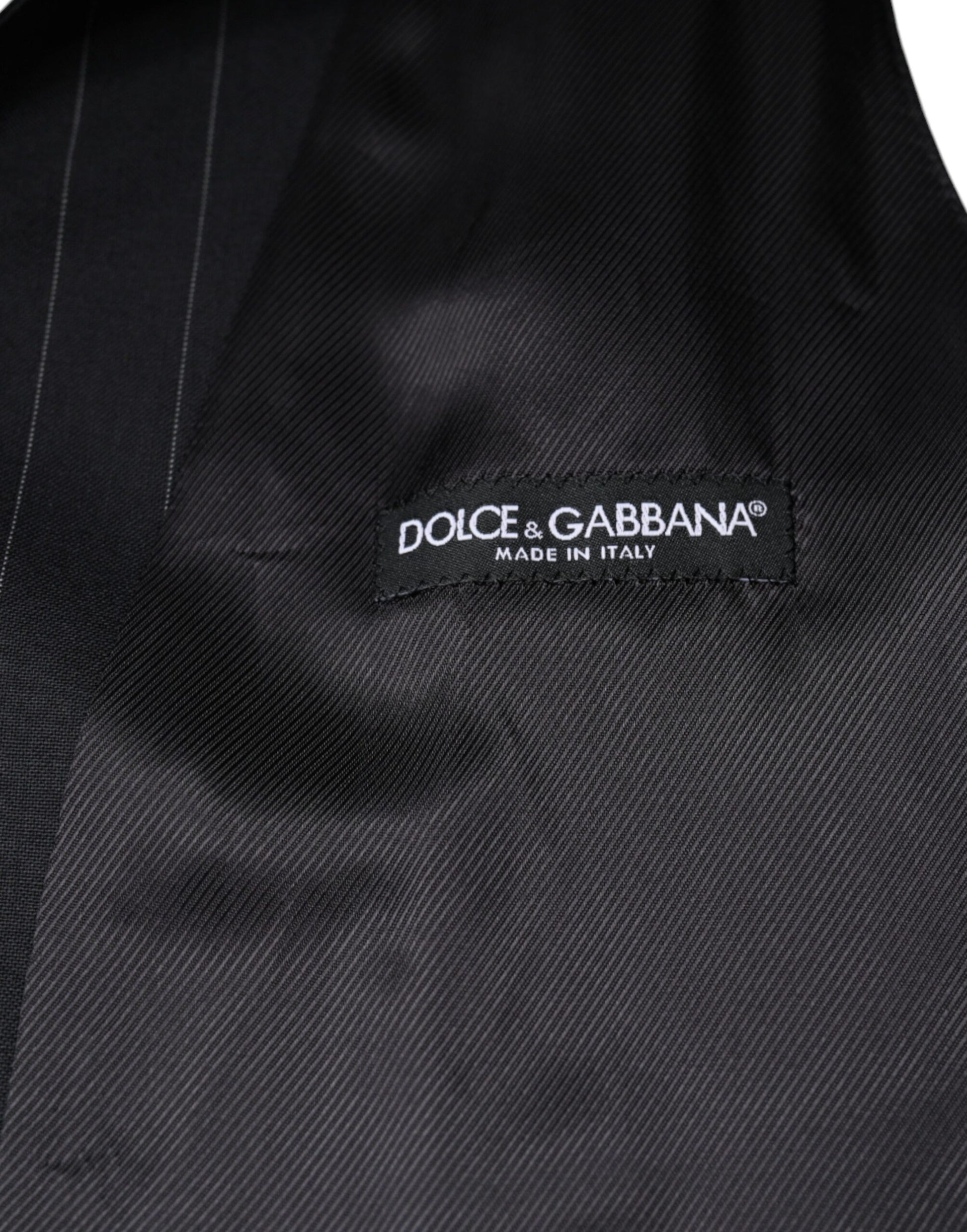 A black leather waistcoat with a label that reads "Dolce & Gabbana"