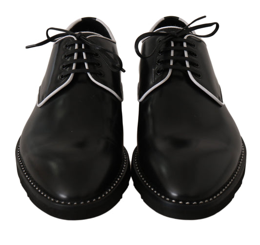 Pair of black dress shoes with white laces and stitching details