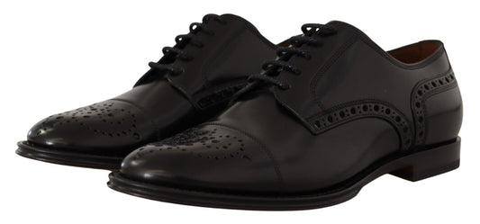 Pair of black leather shoes with laces and a small heel
