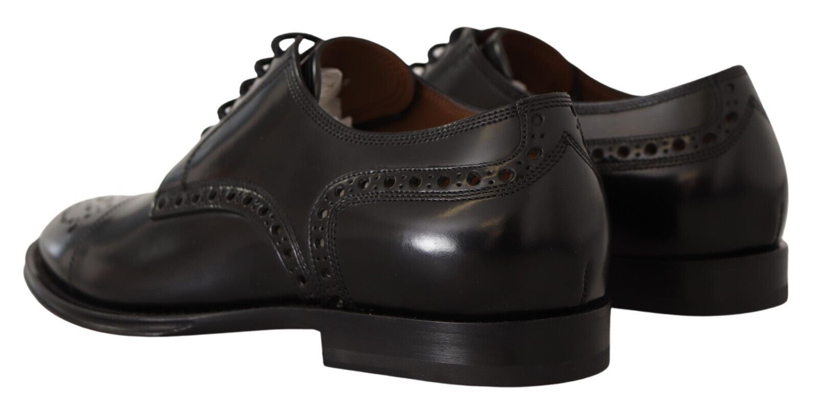 Pair of black dress shoes with laces and a small heel
