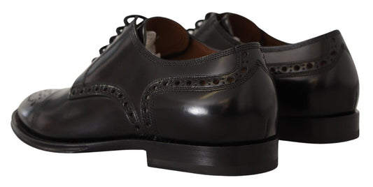 Pair of black dress shoes with laces and a small heel