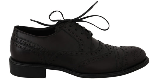 Pair of black dress shoes with laces and decorative stitching