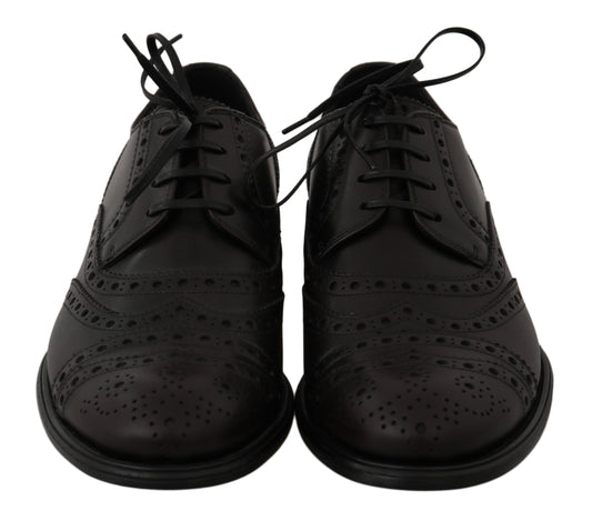 Pair of black lace-up dress shoes with perforated details and a low heel