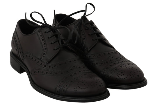 Pair of black leather shoes with laces and perforated design