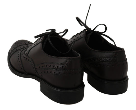 Pair of black leather shoes with laces and a small heel