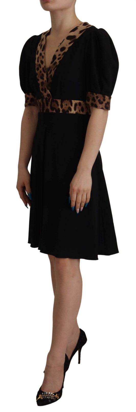 Black leopard print knee length dress with ruffled sleeves and hem