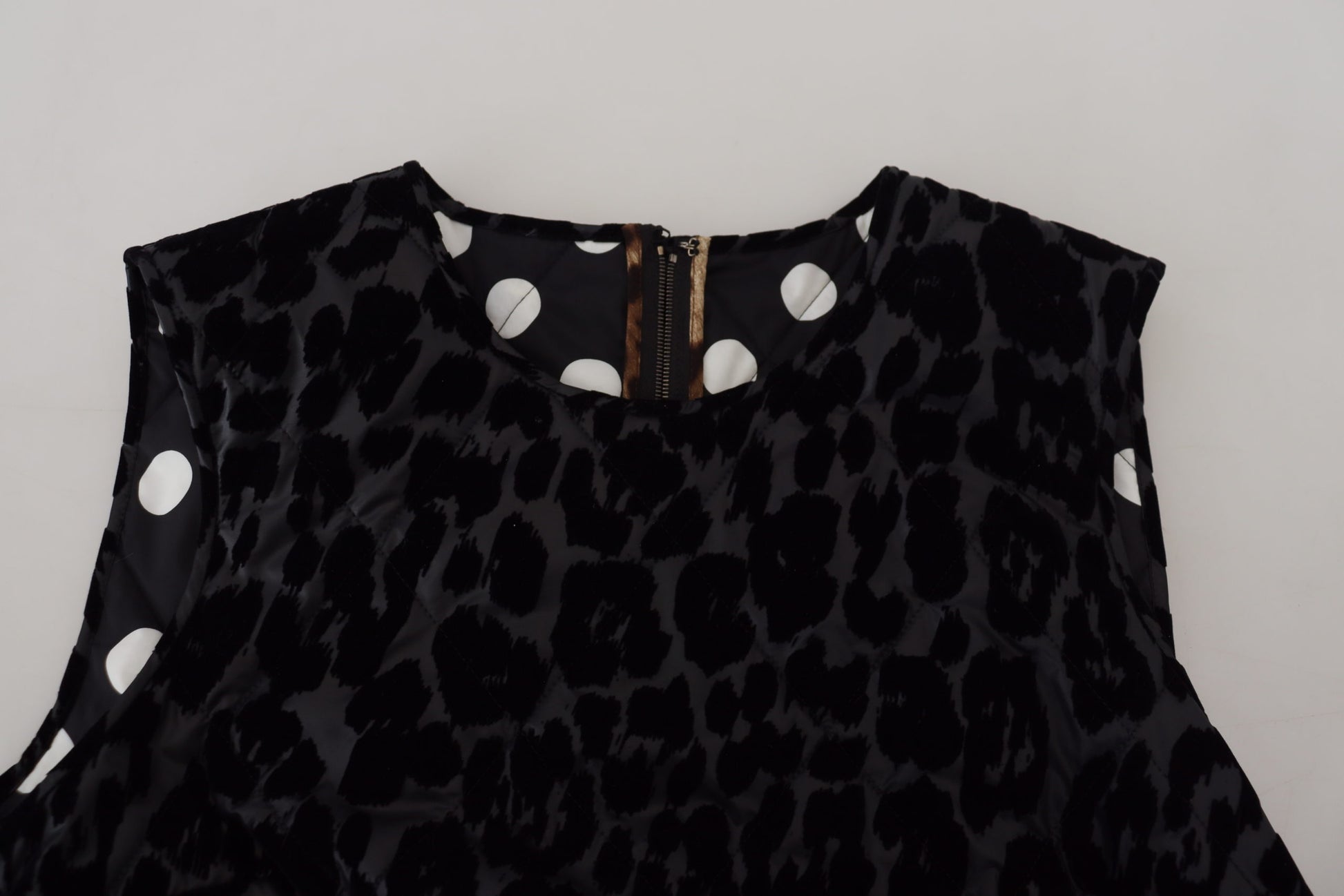 A black leopard print dress with white polka dots and a V-neckline