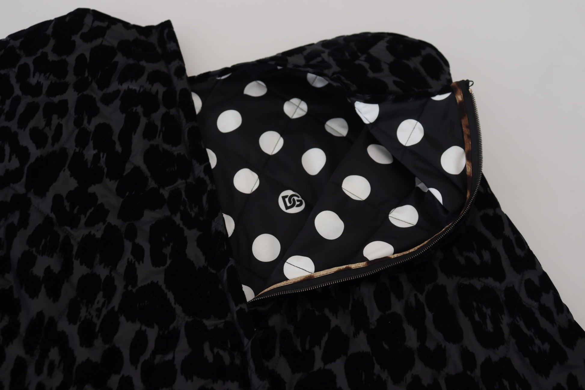 A black leopard print dress with white polka dots and a gold zipper