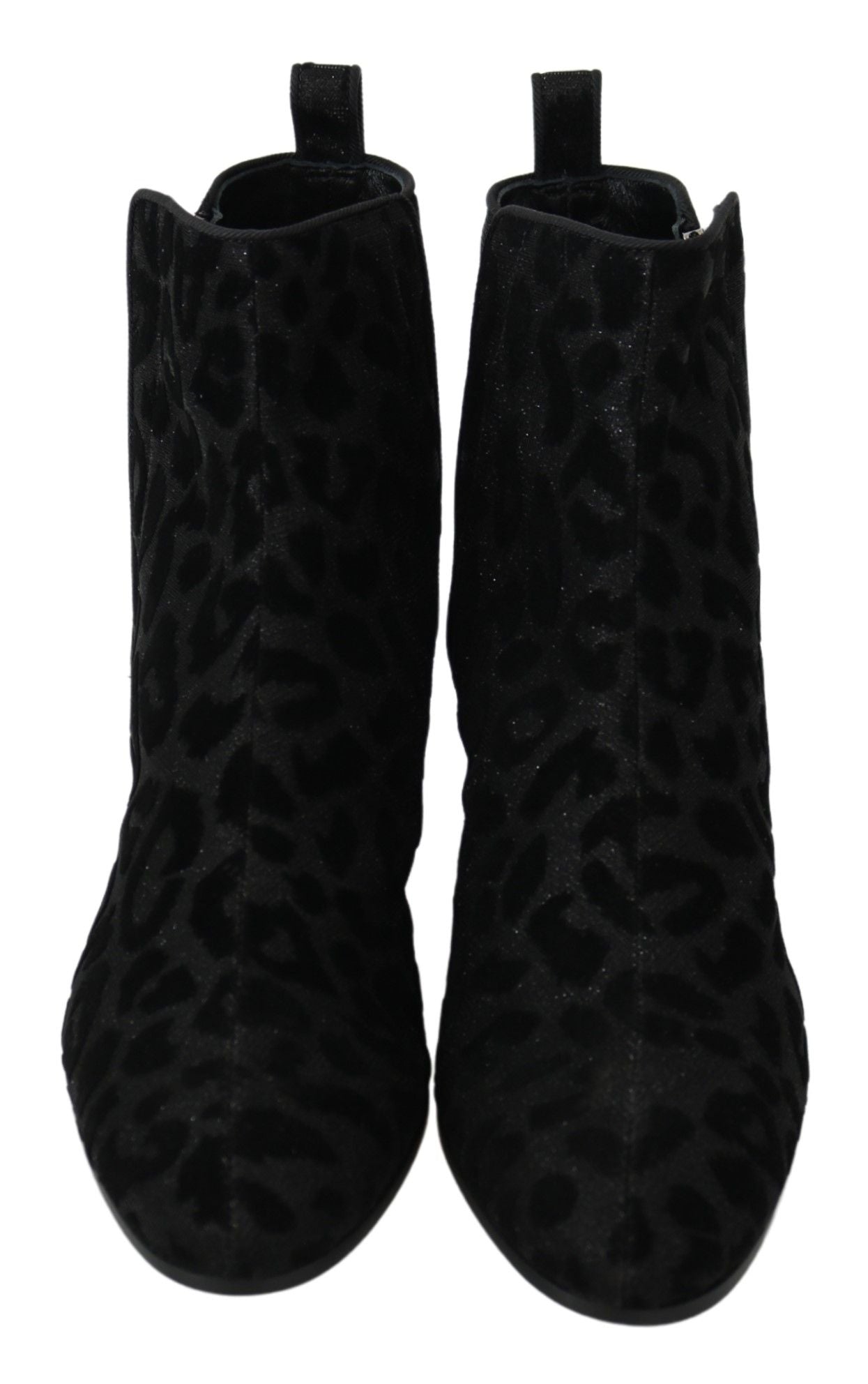 Pair of black knee high boots with animal print pattern