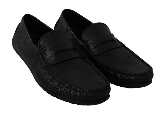 Pair of black loafers with a strap across the top