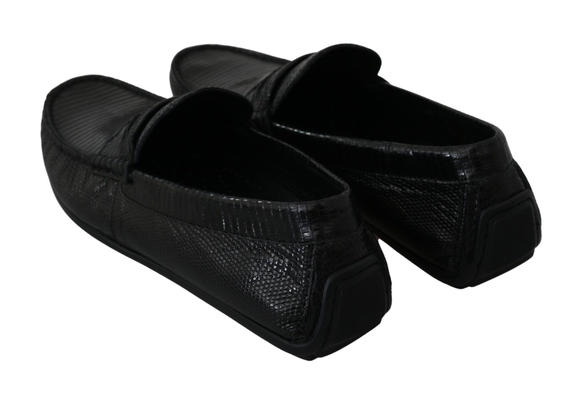 Pair of black patent leather shoes with laces and a strap across the top