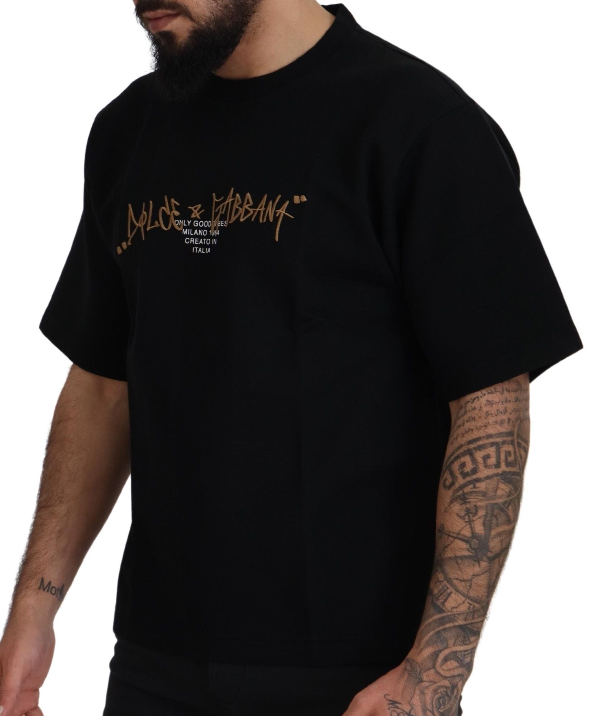 Man wearing black t-shirt with gold lettering